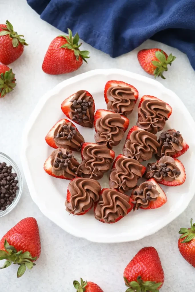 Halved chocolate cheesecake stuffed strawberries on white-gray surface