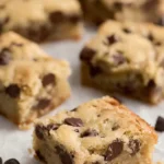 Soft chewy chocolate chip cookie bars with melted chocolate