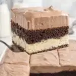 Slice of chocolate love cake with ricotta and pudding layers on a fork
