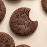 Chocolate sugar cookies with crackled tops and a bite taken out
