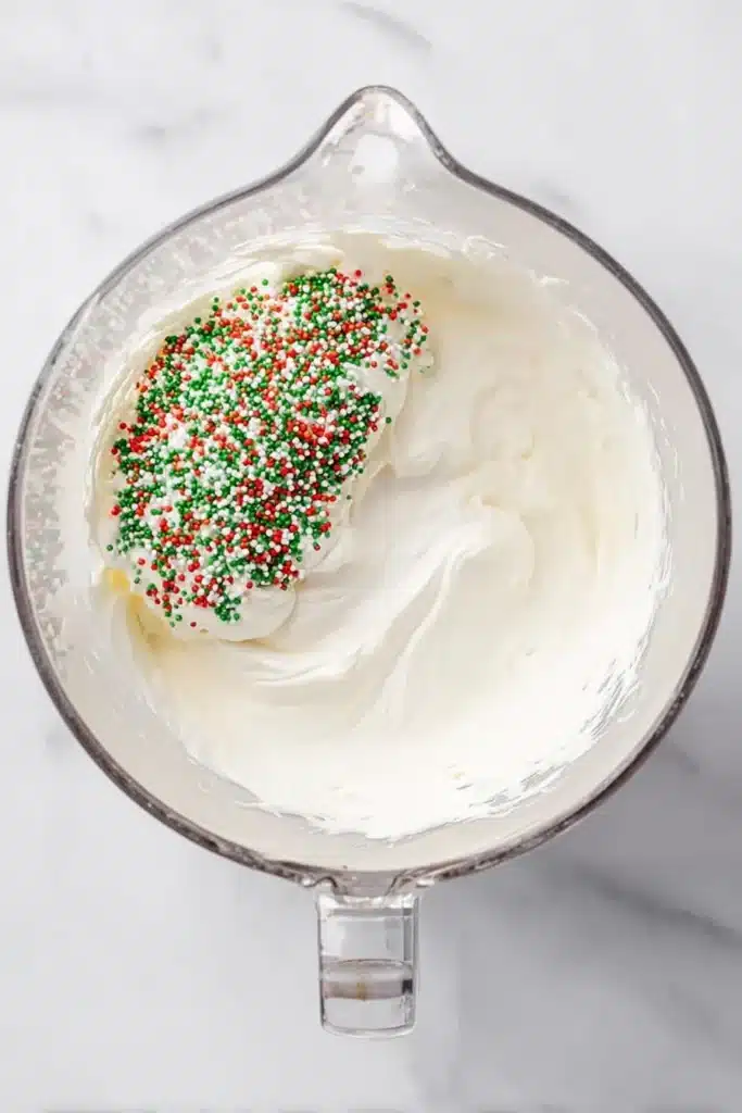 Christmas Cookie Lush Recipe | Easy, Festive & Delicious 27 Creamy mixture with holiday sprinkles for Christmas Cookie Lush filling