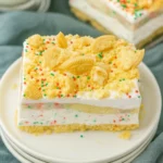 Christmas Cookie Lush slice with creamy layers, vanilla cookies, and holiday sprinkles