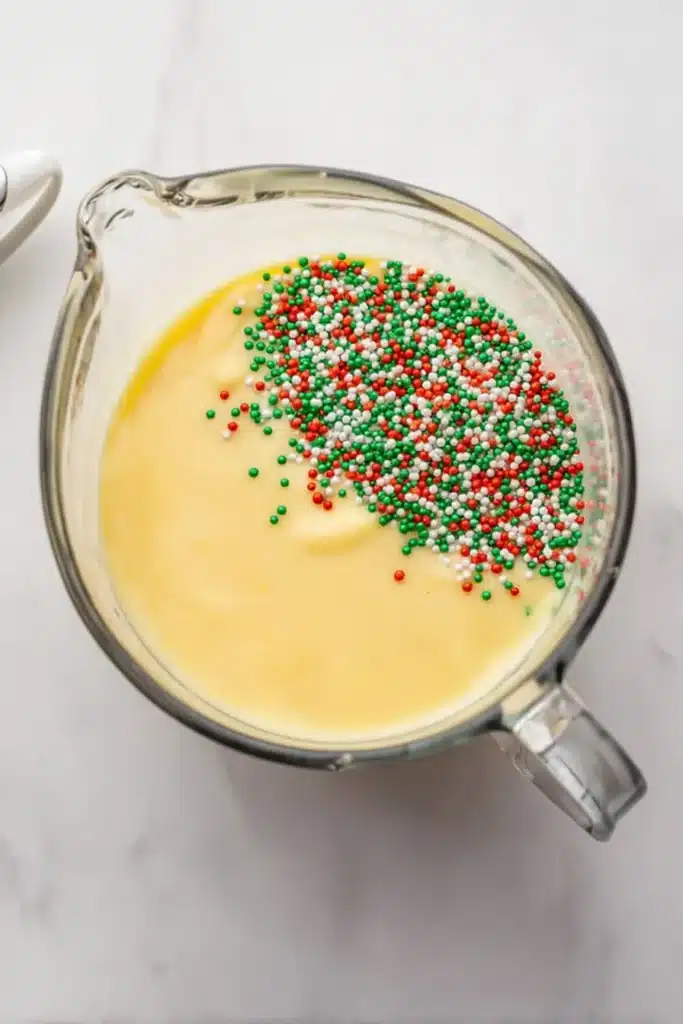 Christmas Cookie Lush Recipe | Easy, Festive & Delicious 28 Cheesecake pudding mixture with holiday sprinkles for Christmas Cookie Lush