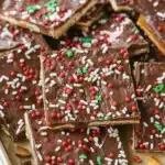 Homemade Christmas Crack candy with chocolate and festive red, white, and green sprinkles