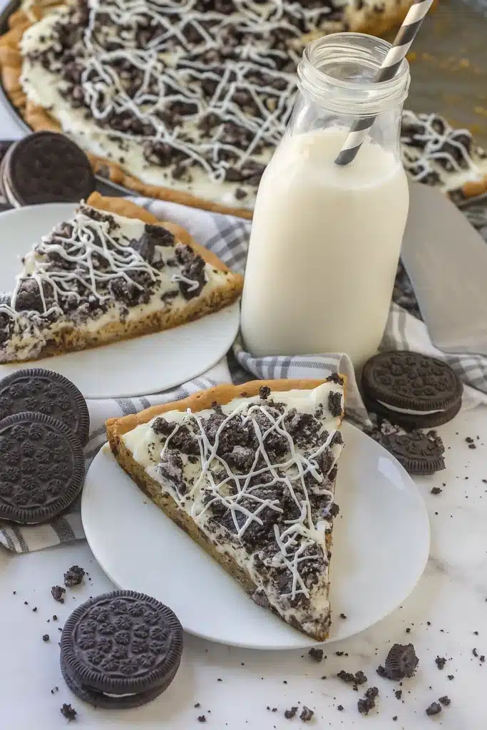 cookies and cream dessert pizza slice with Oreos and cream cheese frosting