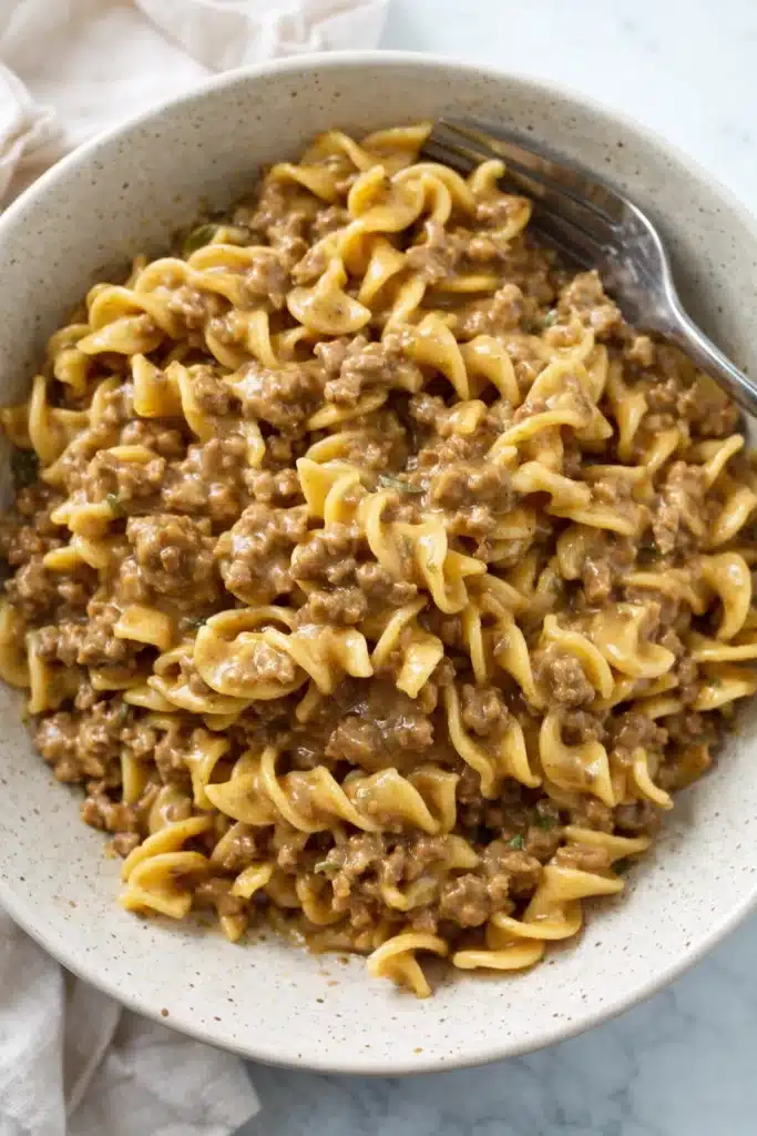 Beef and Noodles: Amazing 35-Minute Comfort Meal 5 Creamy beef and noodles in a white bowl on marble surface