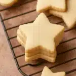 soft golden star-shaped cutout sugar cookies on cooling rack