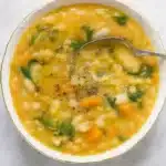 Easy White Bean Soup Recipe in a white bowl on a white-gray table