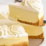 Slice of creamy eggnog cheesecake with whipped cream and nutmeg