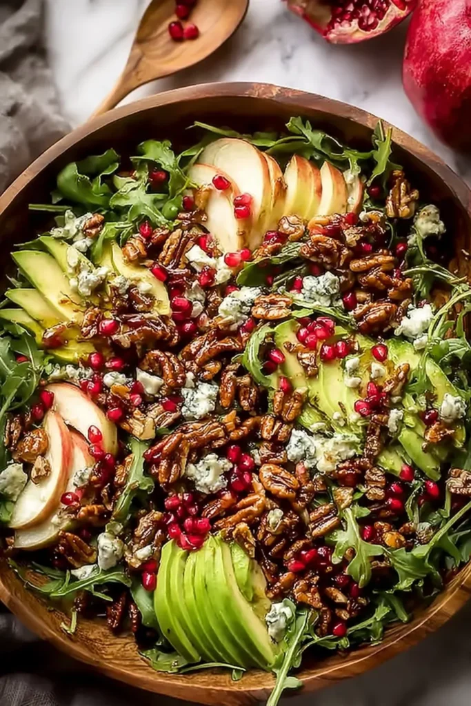 Christmas Salad Recipe: A Fresh, Festive Bowl of Color and Crunch 9 Christmas salad in a wooden bowl with pomegranate, avocado, and candied walnuts