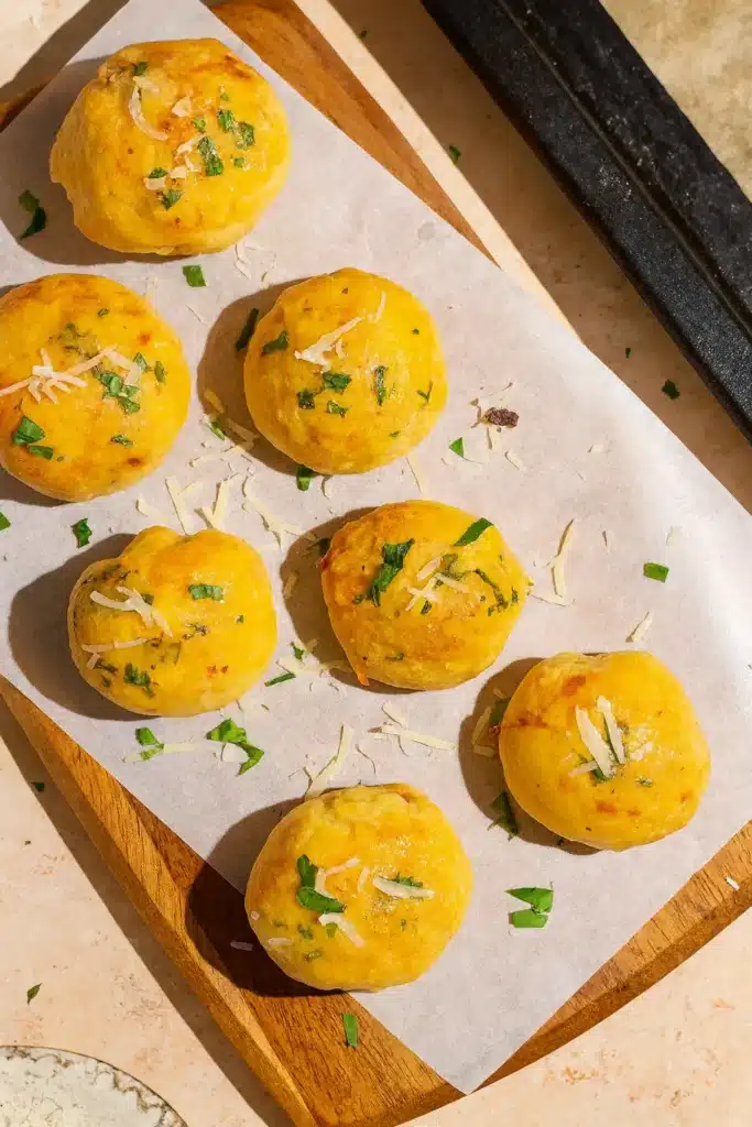 Golden Garlic Parmesan Cheeseburger Bombs fresh from the oven on wooden board