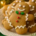 Homemade gingerbread men cookies with white icing and holiday decorations