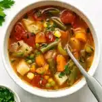 Bowl of homemade vegetable soup with carrots, green beans, and potatoes