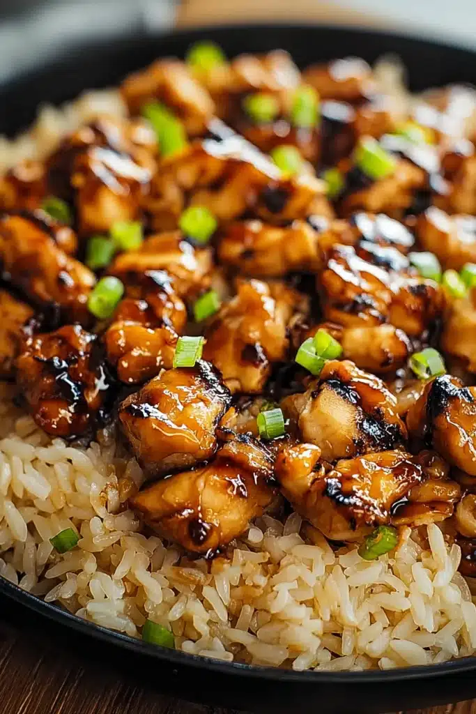 Honey BBQ Chicken Rice | Easy & Delicious Family Favorite 8 Honey BBQ chicken with rice topped with green onions in a rustic bowl