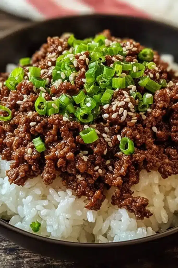 Korean ground beef bowl close-up with sesame seeds and green onions over rice