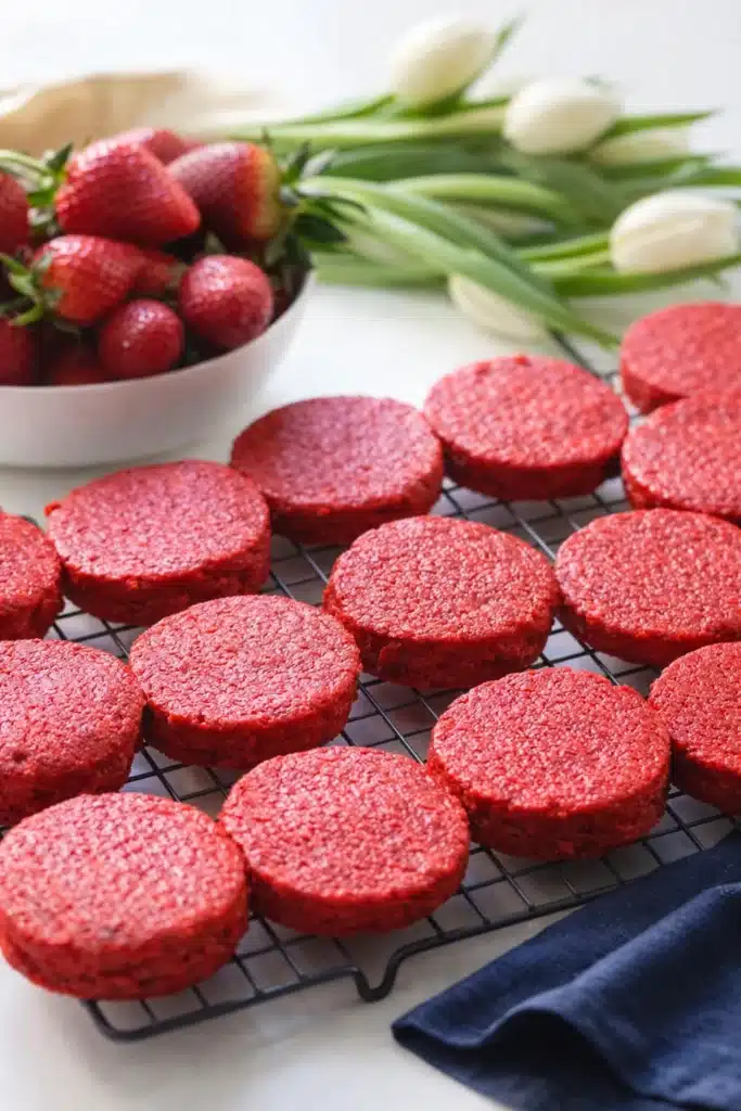 Mini Red Velvet Cakes | Sweet Valentine’s Day Treats 8 Mini red velvet cake rounds cooling on a rack with strawberries