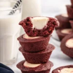 Stack of mini red velvet cheesecakes with creamy cheesecake centers
