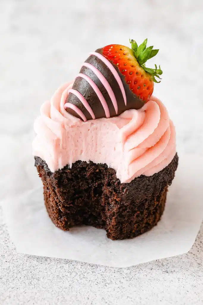 Easy Chocolate Covered Strawberry Cupcakes Recipe 8 Chocolate covered strawberry cupcake with bite showing moist texture