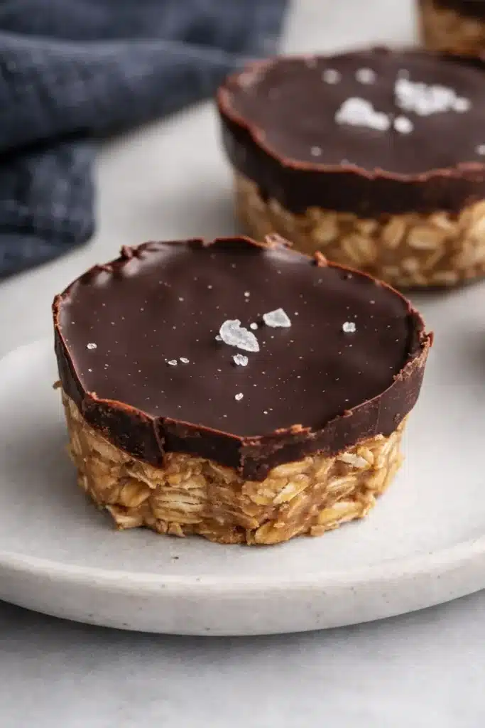 No bake peanut butter oat cups topped with dark chocolate and sea salt