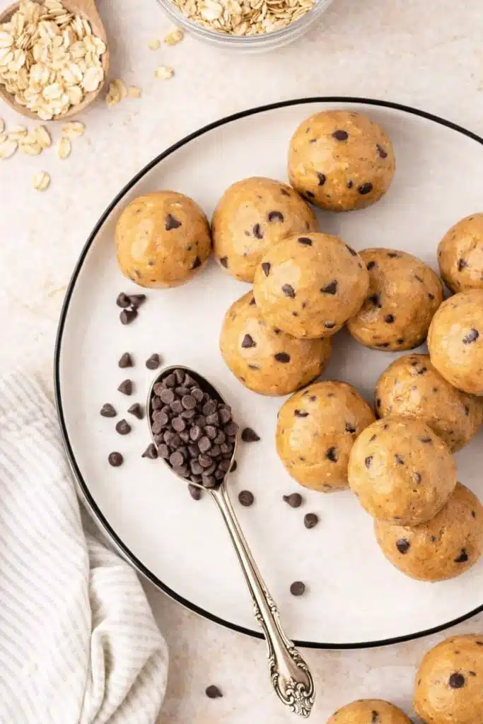 No Bake Protein Balls – Simple and Powerful Snack 17 Plate of no bake peanut butter protein balls with chocolate chips and oats