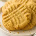 peanut butter cookies on a plate with golden crispy edges