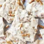 Top-down peanut butter pretzel bark with pretzel chunks on parchment