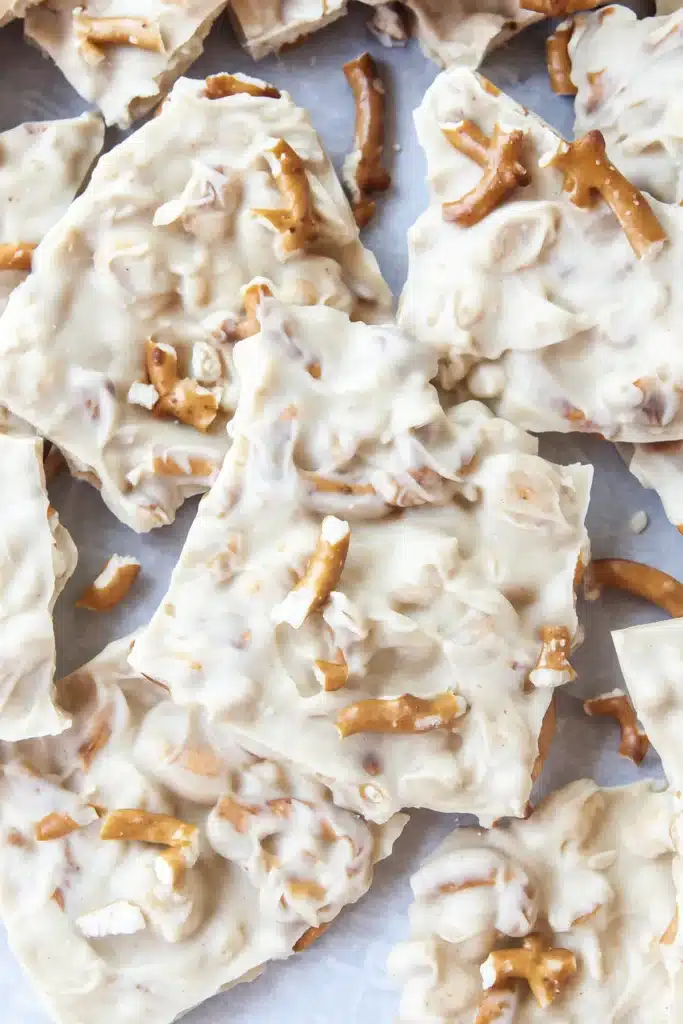 Peanut Butter Pretzel Bark Recipe | Delicious Treat 8 Top-down peanut butter pretzel bark with pretzel chunks on parchment