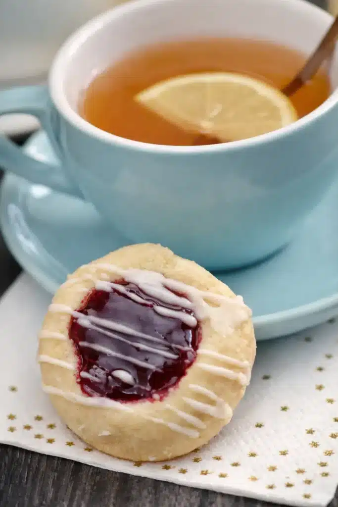 Raspberry Thumbprint Cookies with Icing – Simple Joy 14 Raspberry thumbprint cookie with icing served with tea and lemon