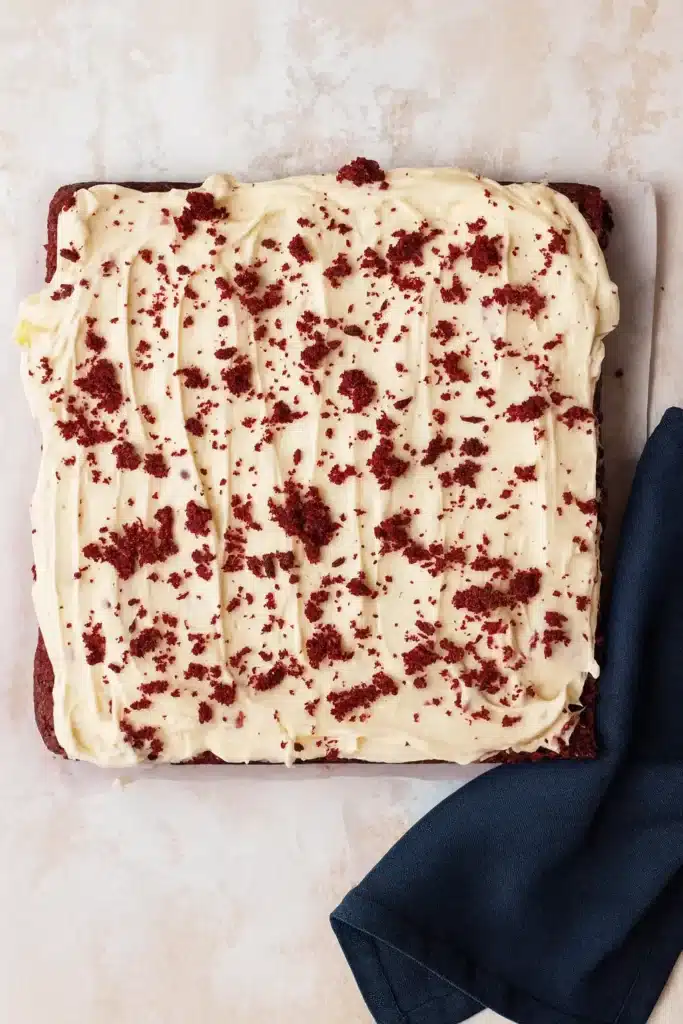 Red Velvet Brownies | Ultimate Fudgy Treat Recipe 13 Red velvet brownie slab topped with cream cheese frosting and red crumbs