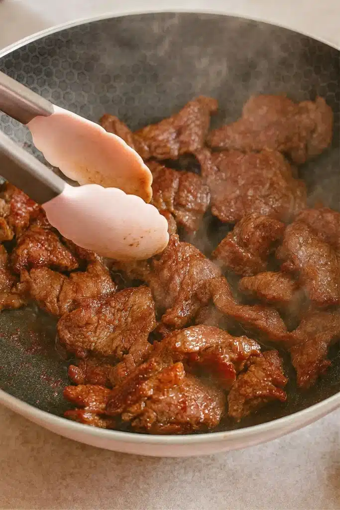 Easy Chinese Beef and Broccoli | Quick & Delicious Dinner 8 Beef searing in a wok for Chinese beef and broccoli recipe