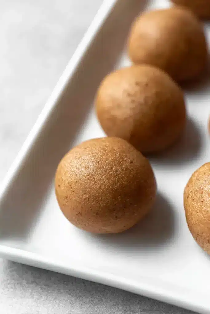 Tiramisu Balls Recipe – Easy, Creamy & Irresistible Treat 12 Uncoated tiramisu balls rolled and placed on a white plate