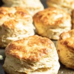 Golden flaky sourdough discard biscuits on a baking tray