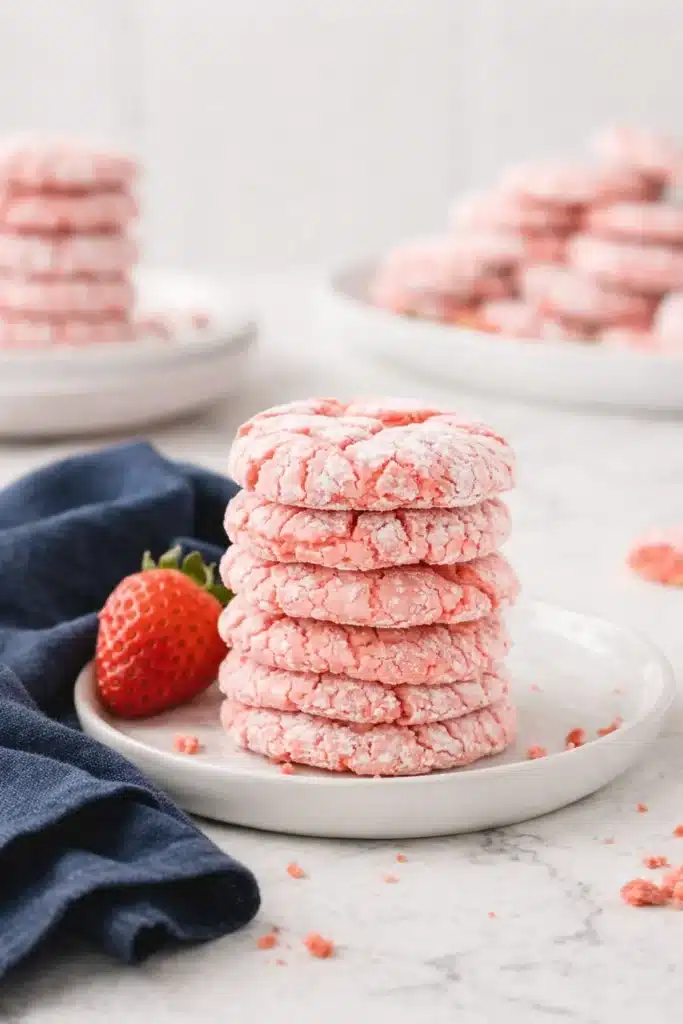 Strawberry Cake Mix Cookies | Easy & Delicious Recipe 9 Stack of strawberry cake mix cookies with powdered sugar and fresh strawberry