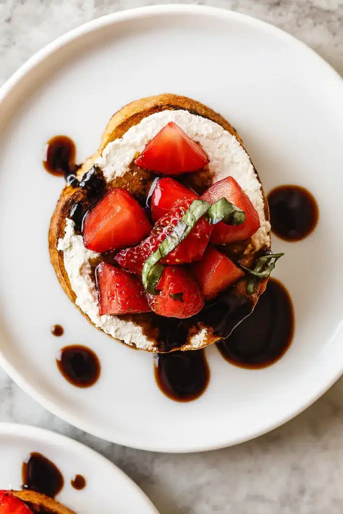 Top view of strawberry goat cheese bruschetta with balsamic drizzle