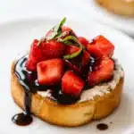 Strawberry goat cheese bruschetta with balsamic glaze and basil