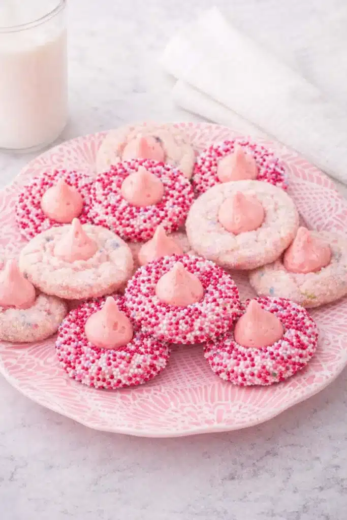 Strawberry Kiss Cookies on pink plate with white napkin and milk