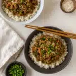 Teriyaki turkey rice bowls with sesame seeds and vegetables in bowls