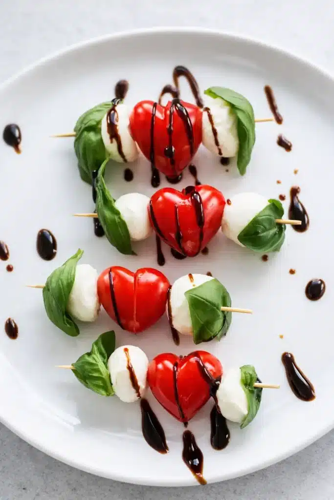 Heart Shaped Valentines Caprese Skewers Recipe 8 Heart-shaped Caprese skewers with basil, mozzarella, and balsamic drizzle