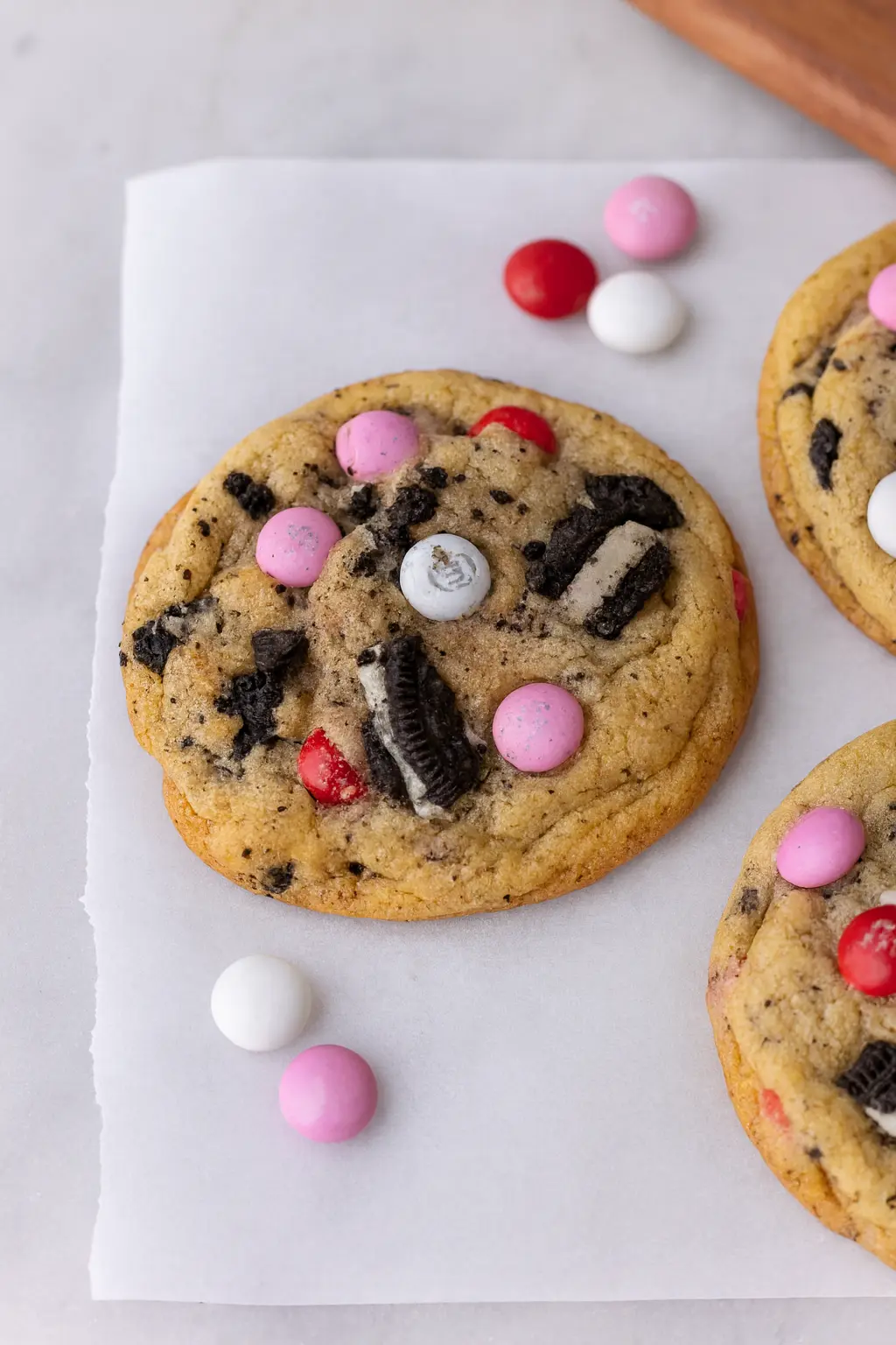 valentines day oreo mms cookies with pink and red candies on marble board