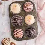 Assorted Valentine’s hot chocolate bombs with pink and white chocolate and festive sprinkles