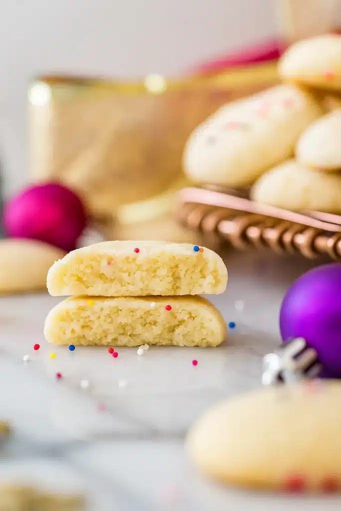 Close-up of broken whipped shortbread cookie showing soft, buttery inside
