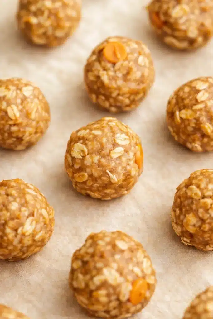Butterscotch protein balls with oats on tan parchment paper