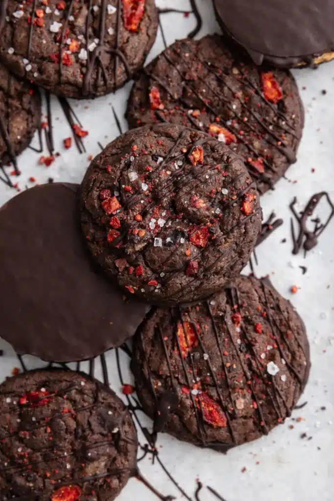 Chocolate covered strawberry cookies with dark chocolate drizzle and strawberry bits