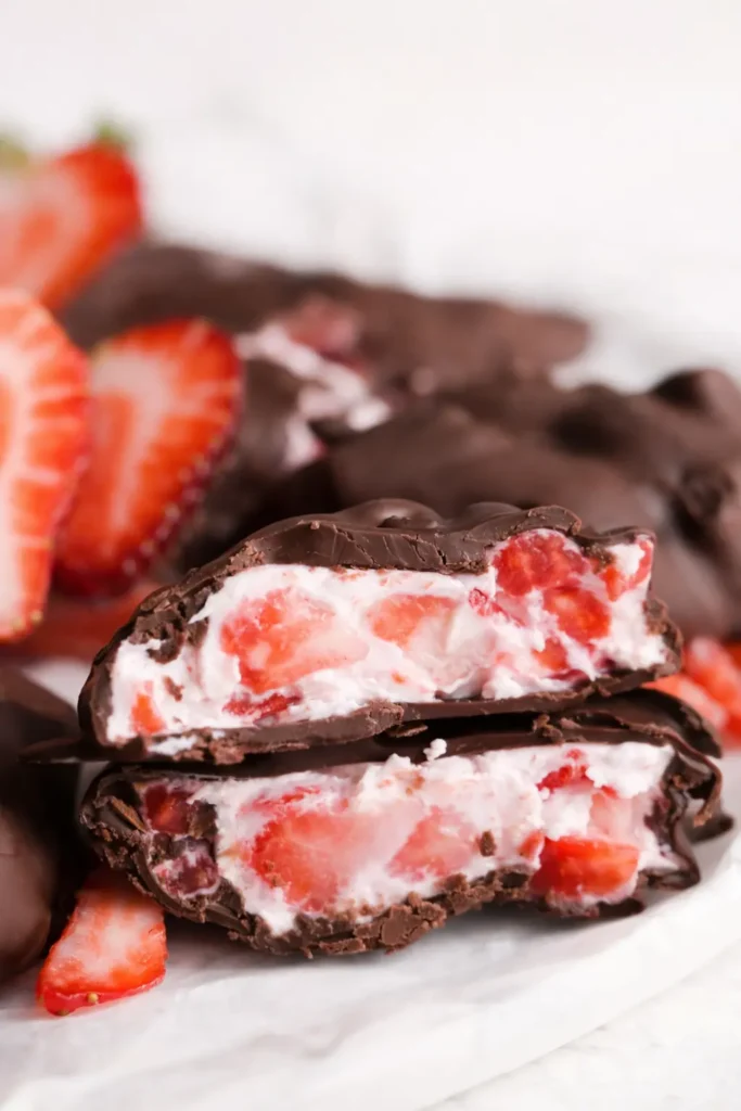 Chocolate strawberry yogurt cluster sliced open with creamy yogurt and fresh strawberries