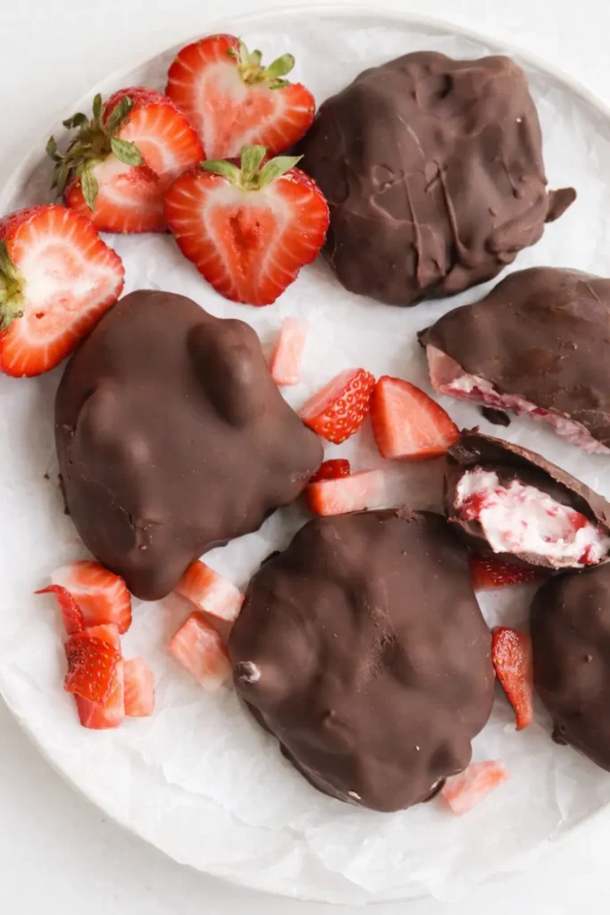  Chocolate strawberry yogurt clusters on plate with fresh strawberries