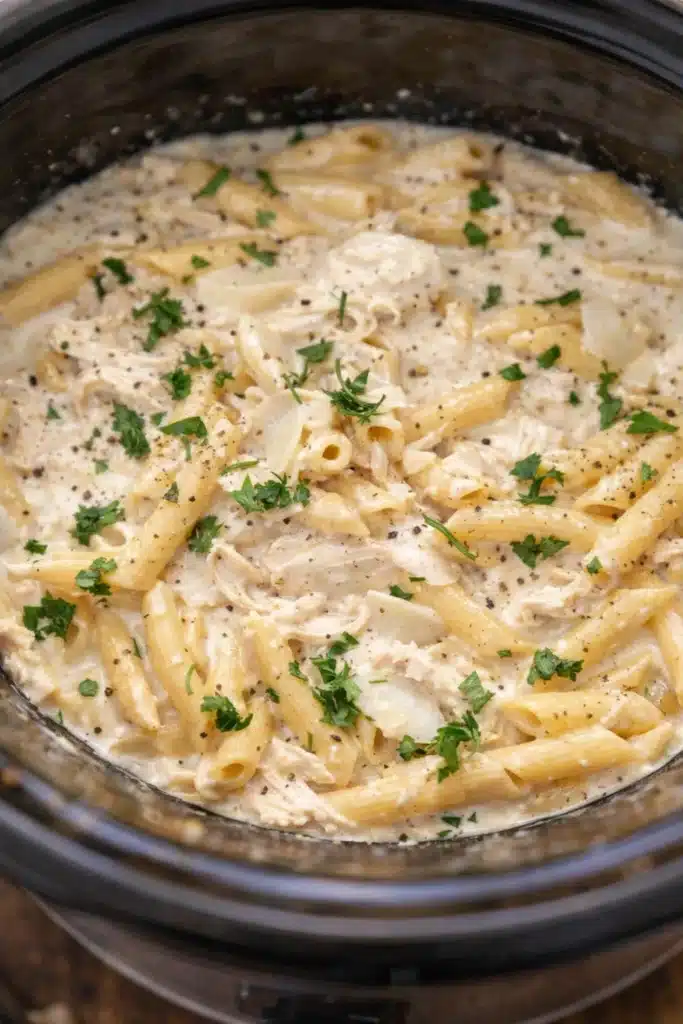 The BEST Crockpot Chicken Alfredo | Creamy & Delicious Dinner 6 Creamy Crockpot Chicken Alfredo in slow cooker with parsley and parmesan