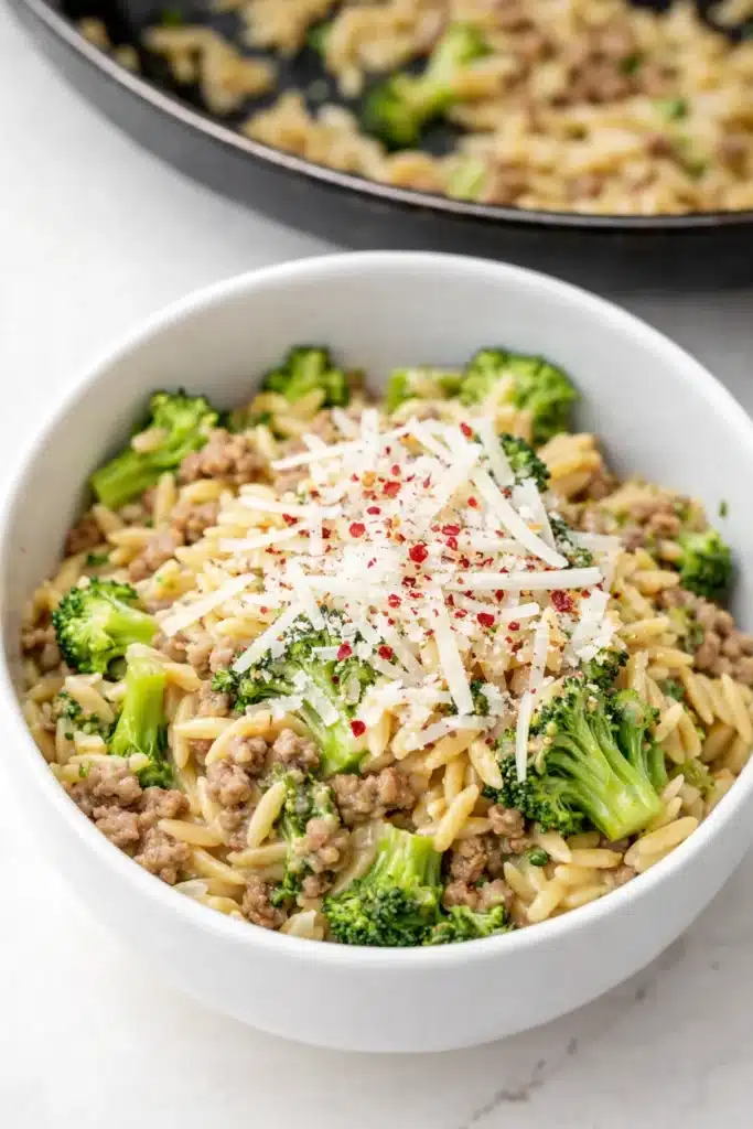  Bowl of creamy ground turkey orzo with broccoli and parmesan