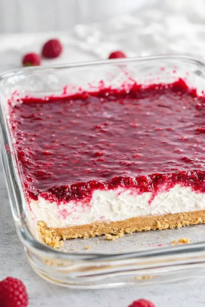 Creamy Raspberry Cheesecake | Simple, Delicious & Smooth 6 No-bake creamy raspberry cheesecake in glass baking dish with graham crust
