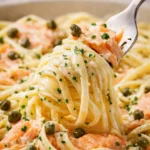 Fork twirling creamy smoked salmon linguine with capers