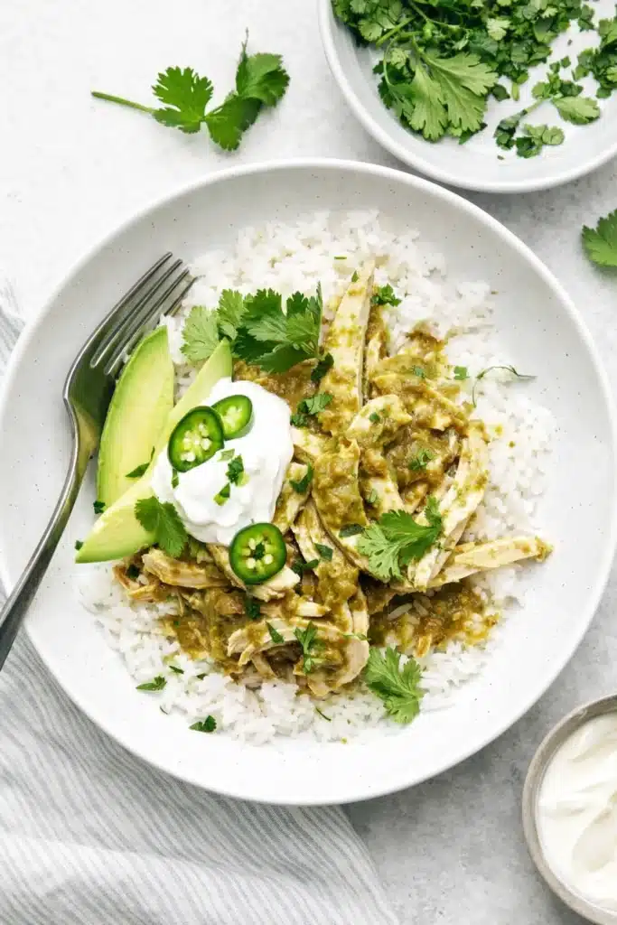 Crockpot Salsa Verde Chicken | Easy, Flavorful Dinner Recipe 4 Crockpot salsa verde chicken bowl with rice, avocado, and sour cream